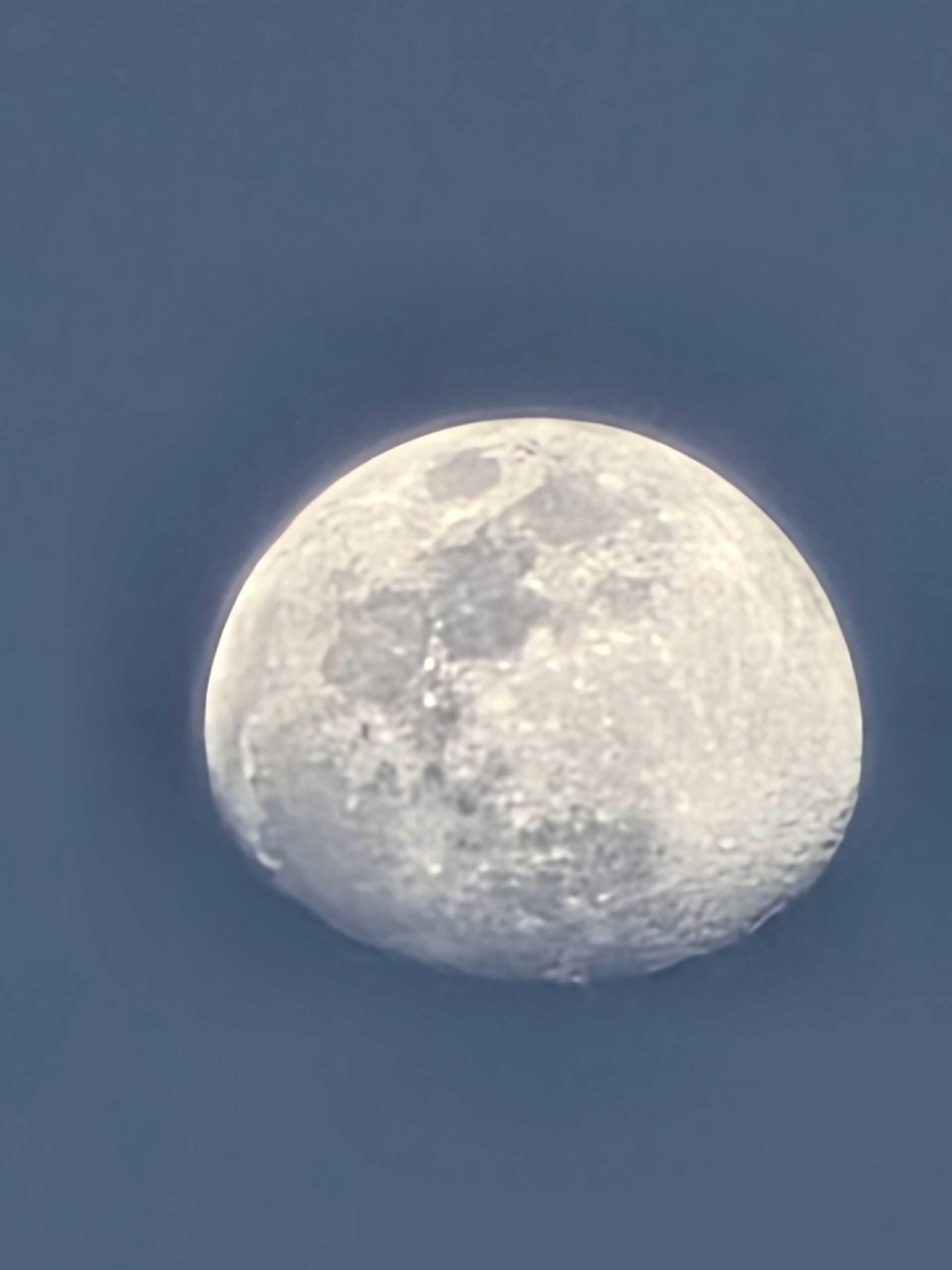 Detailed view of a bright full moon against the evening sky